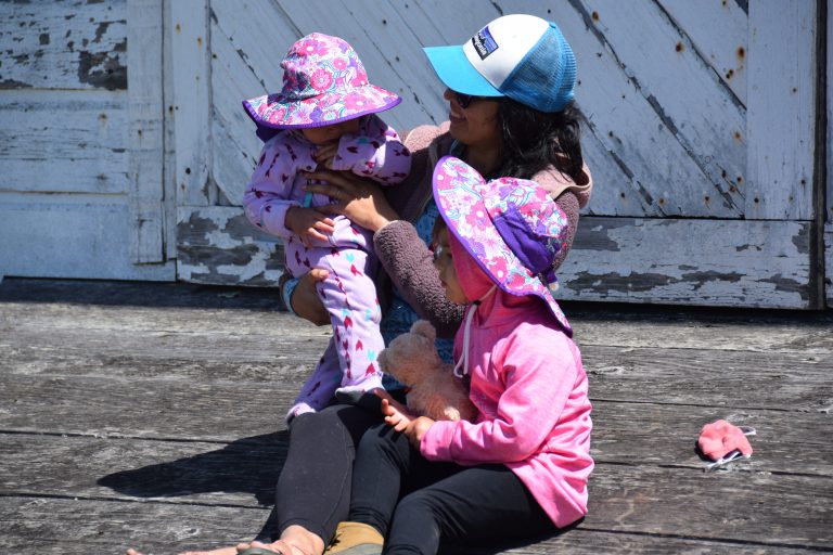 Adult with two little kids in hats at the Pierce Point Ranch at Point Reyes National Seashore