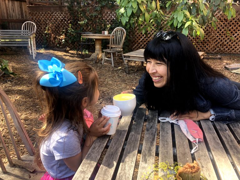 parent clinking coffee mugs with a child