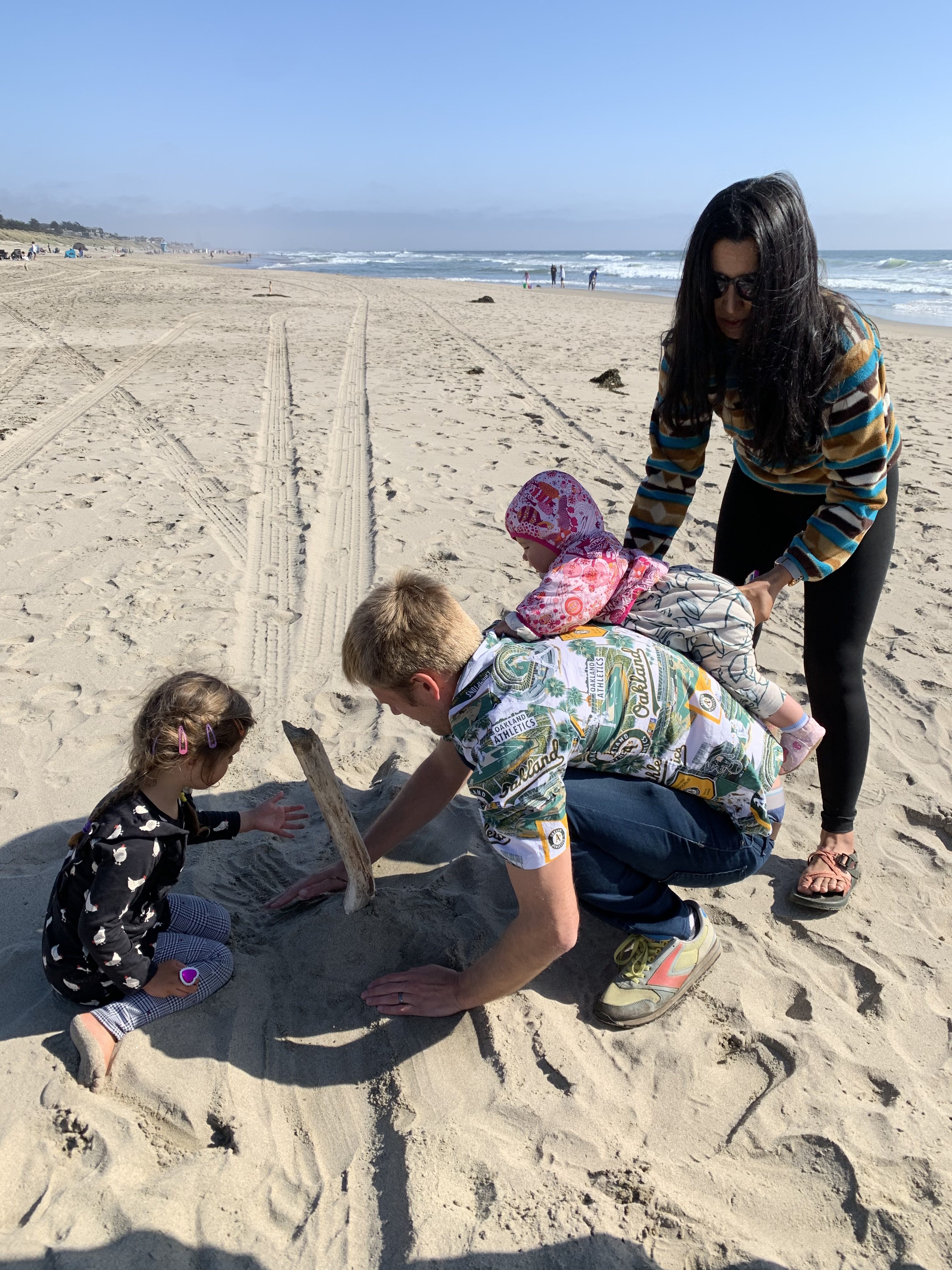 Angel, her two daughters, and her husband play in the sand at Pajaro Dunes, Watsonville.