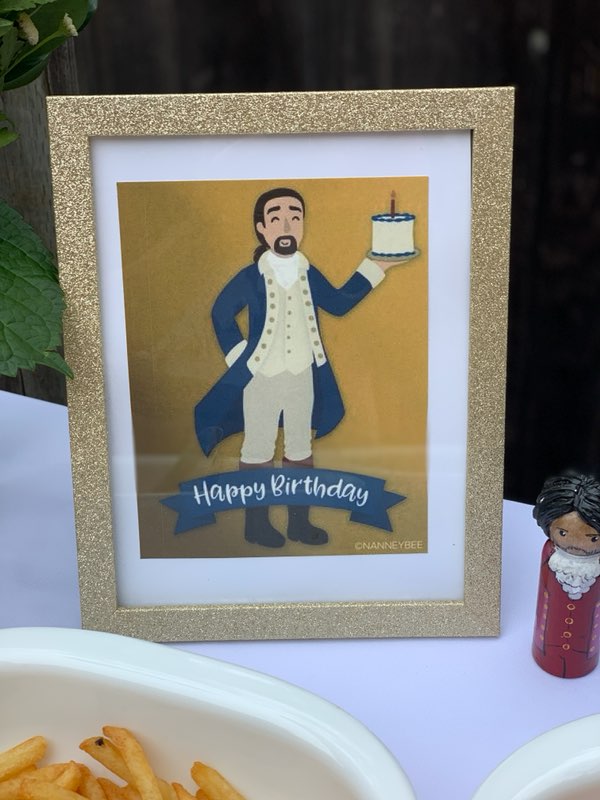 Framed Image of Hamilton holding a birthday cake
