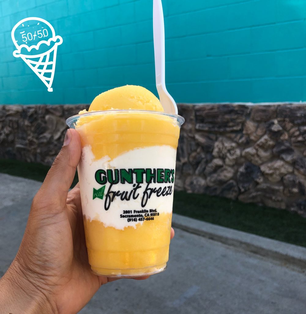A photo of a hand holding an orange and vanilla 50/50 from Gunther's in Sacramento.