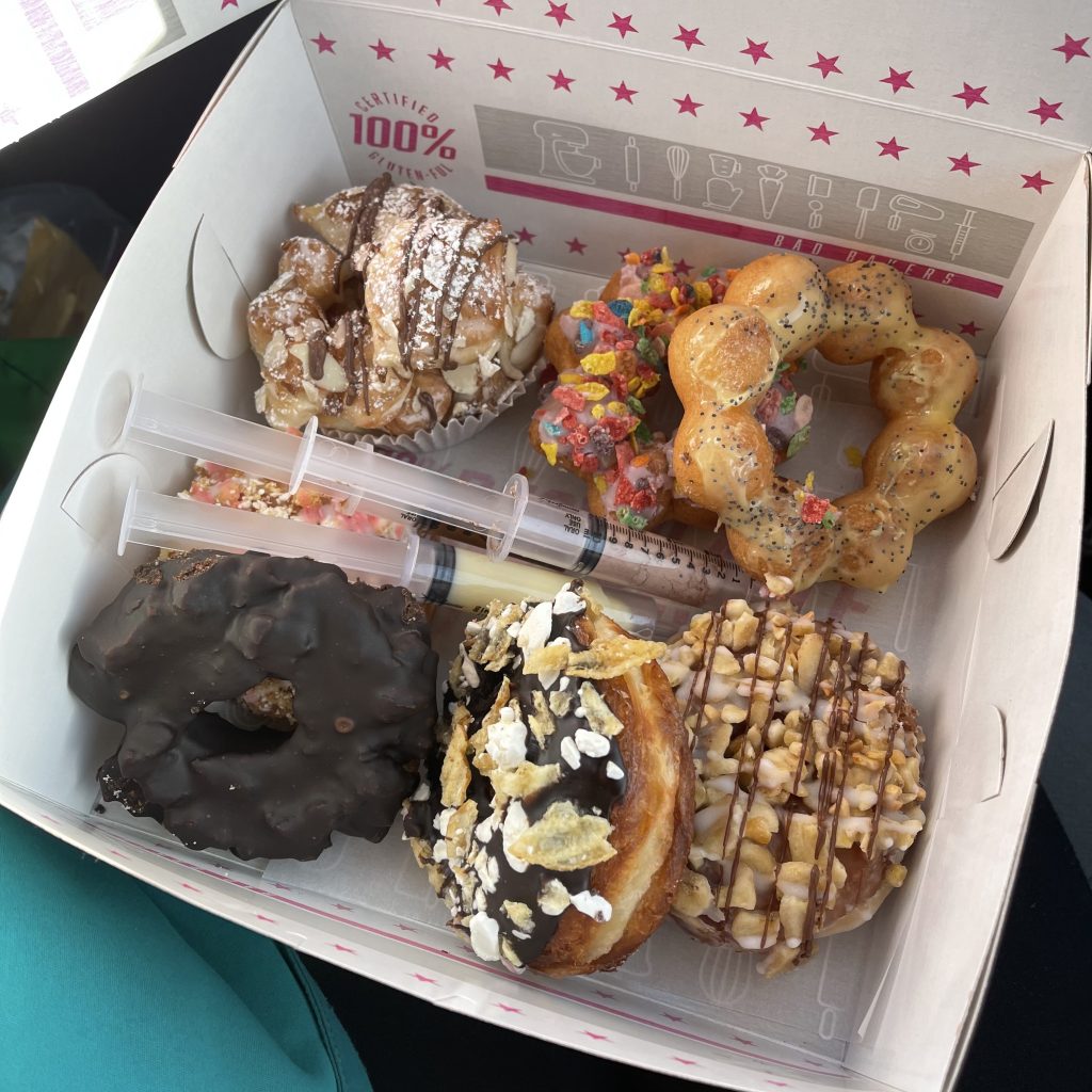 An open box of a donut assortment from Bad Bakers.