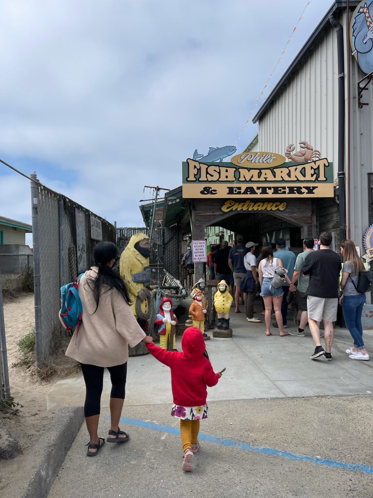 Family walking into Phils Fish Market in Moss landing