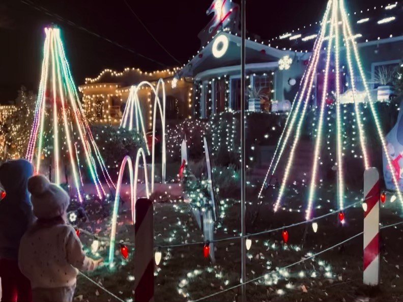 Two children looking at Christmas lights at