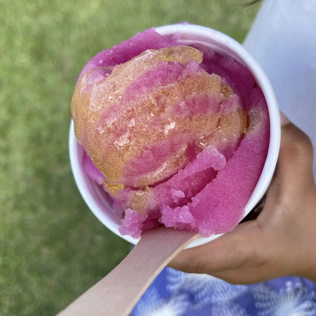 A pink icee drizzled with honey.