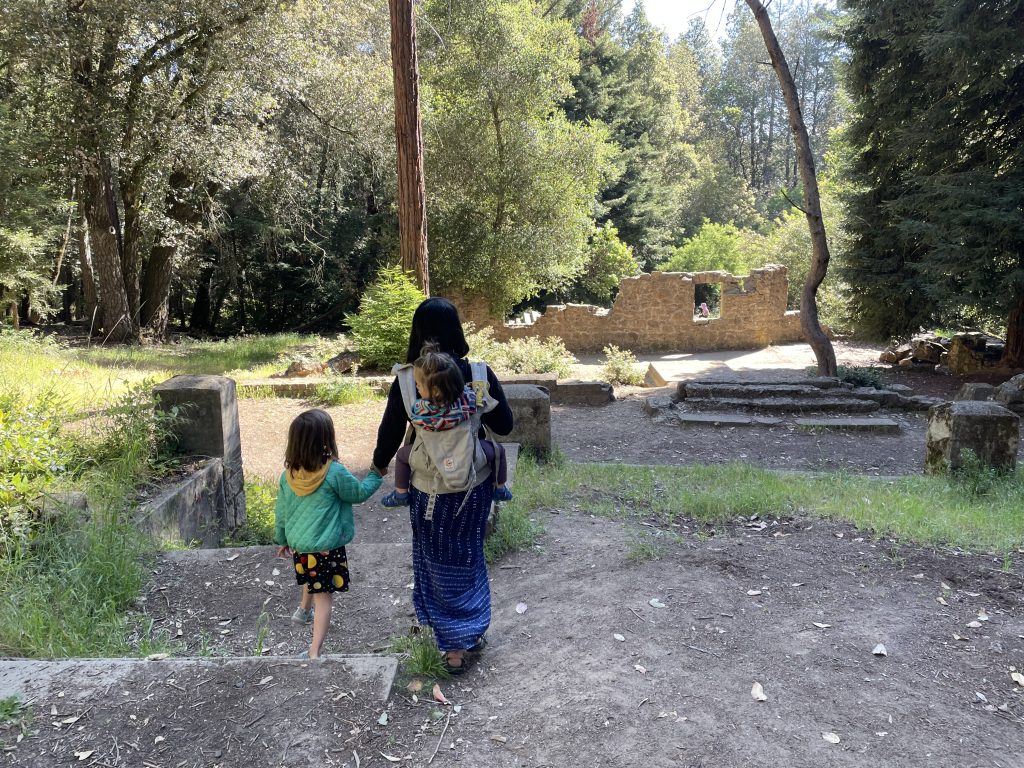 A parent with a child in an Ergo and a preschooler hiking at Mt Madonna County Park in Watsonville, California