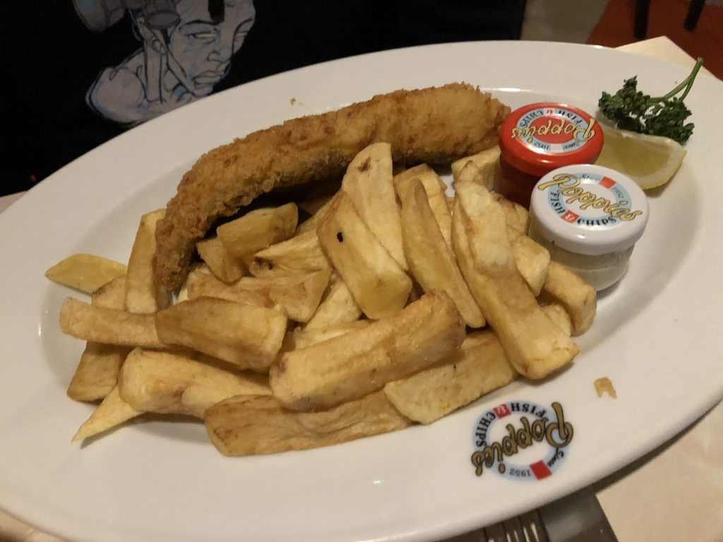 A platter of fried fish and steak cut french fries at Poppies in London