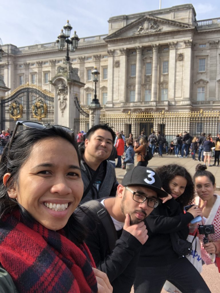 Angelica and four family members smile in front of Buckingham Palace.