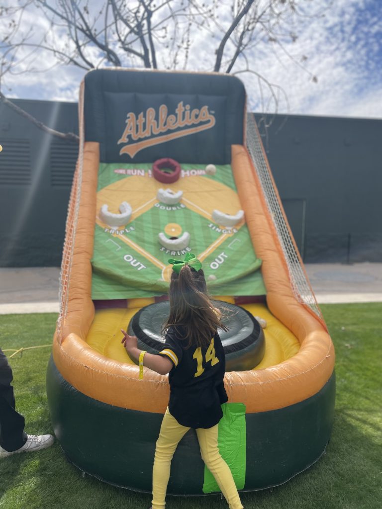 Child playing a blown up skeeball game
