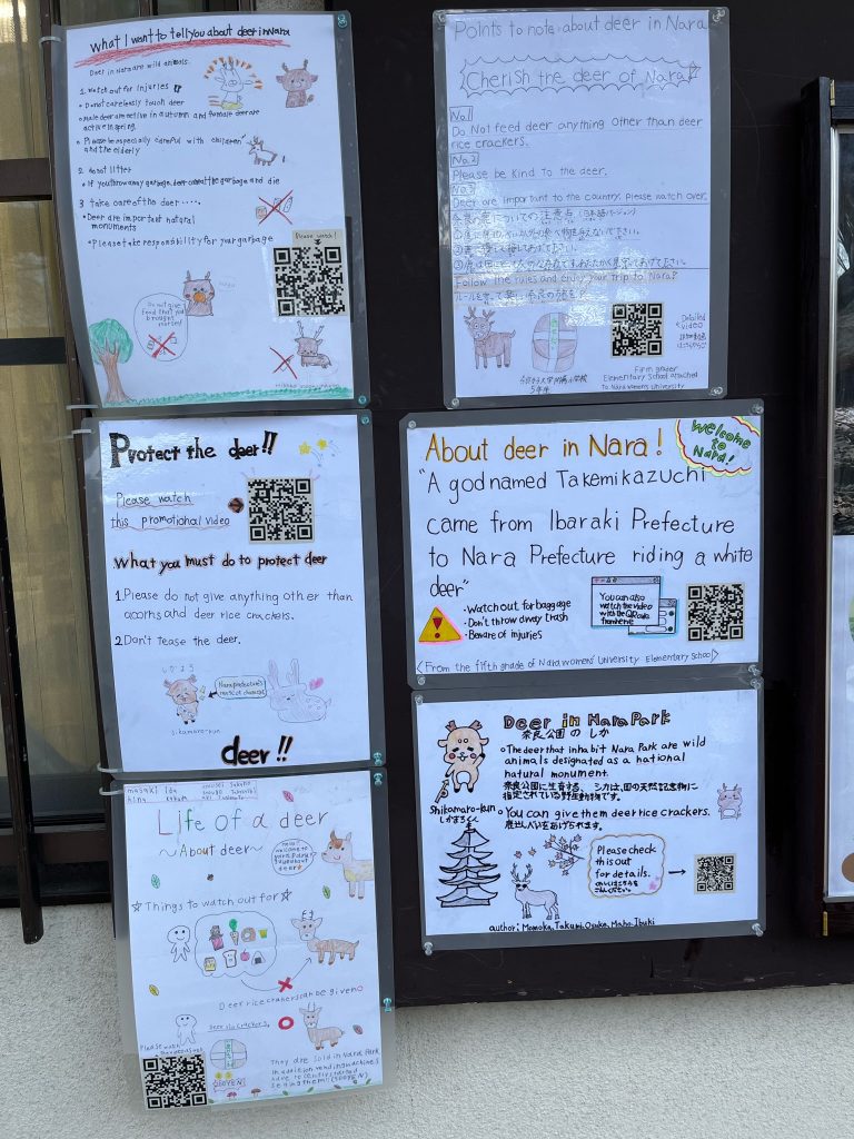 Signs posted on a wall provide facts about the deer in Nara and pleas to protect the deer.