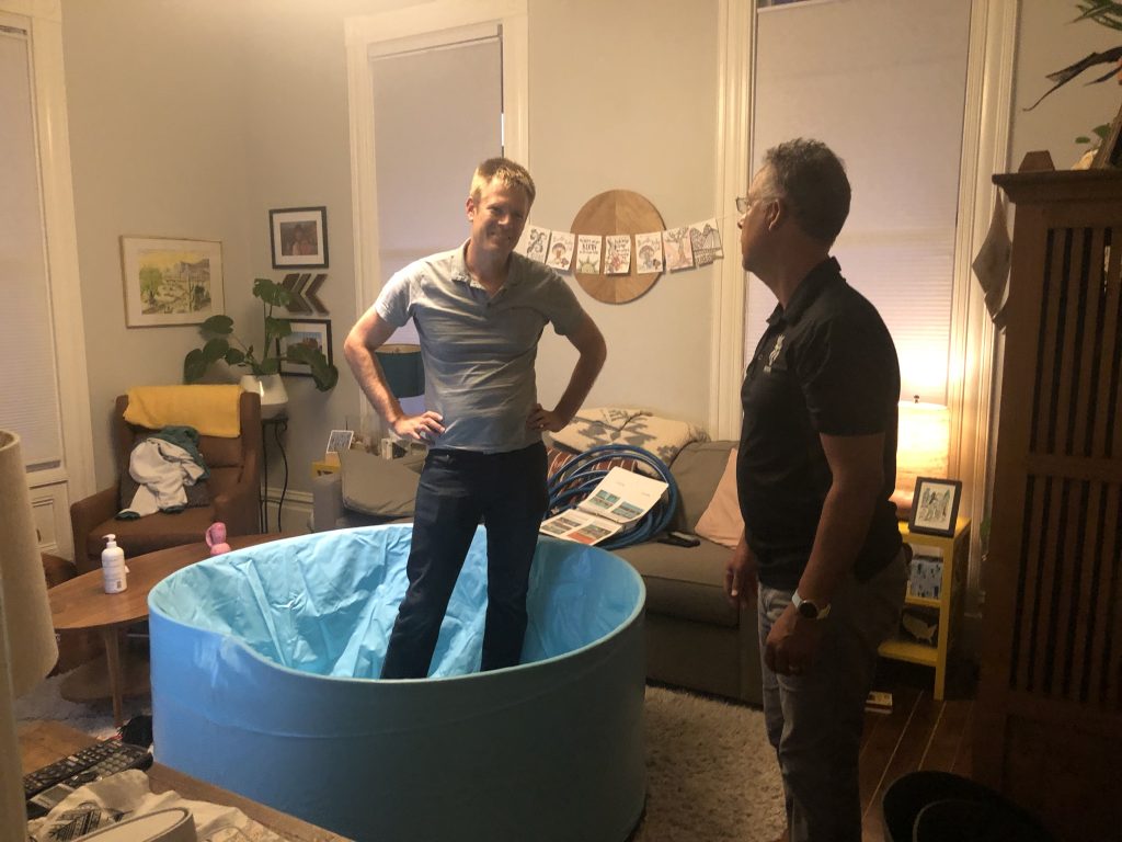 Two people setting up a birthing tub for a homebirth