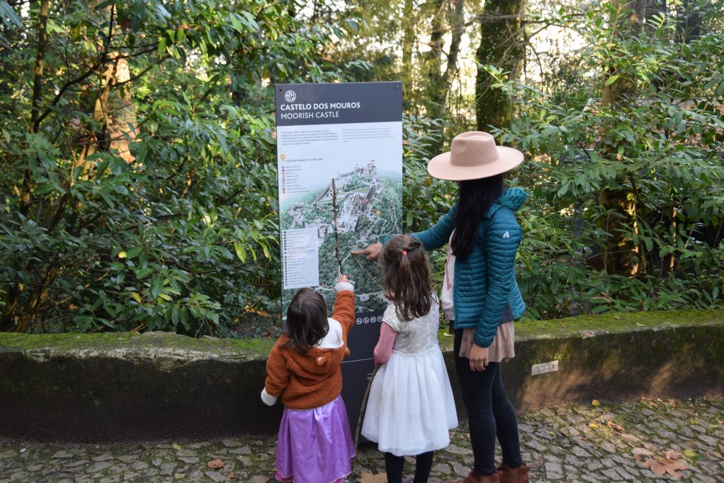 Adult and two children looking at the map of the Moorish Castle Portugal Sintra