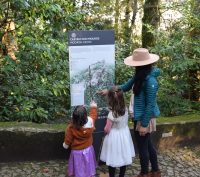 Adult and two children looking at the map of the Moorish Castle Portugal Sintra