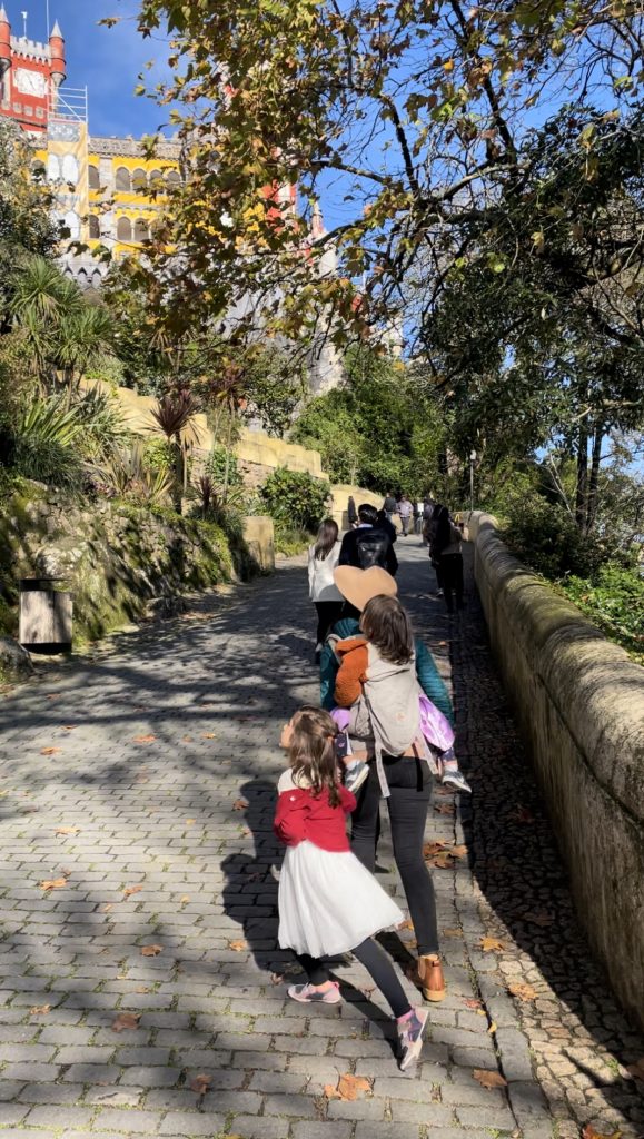 A family walking towards Pena Palace in Sintra, Portugal