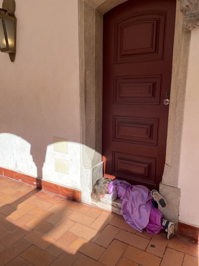 A child asleep on the door in Pena Palace Sintra Portugal