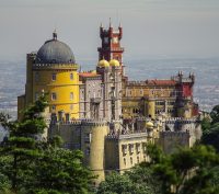 The yellow and orange Pena palace sits atop the Sintra Hills in Portugal