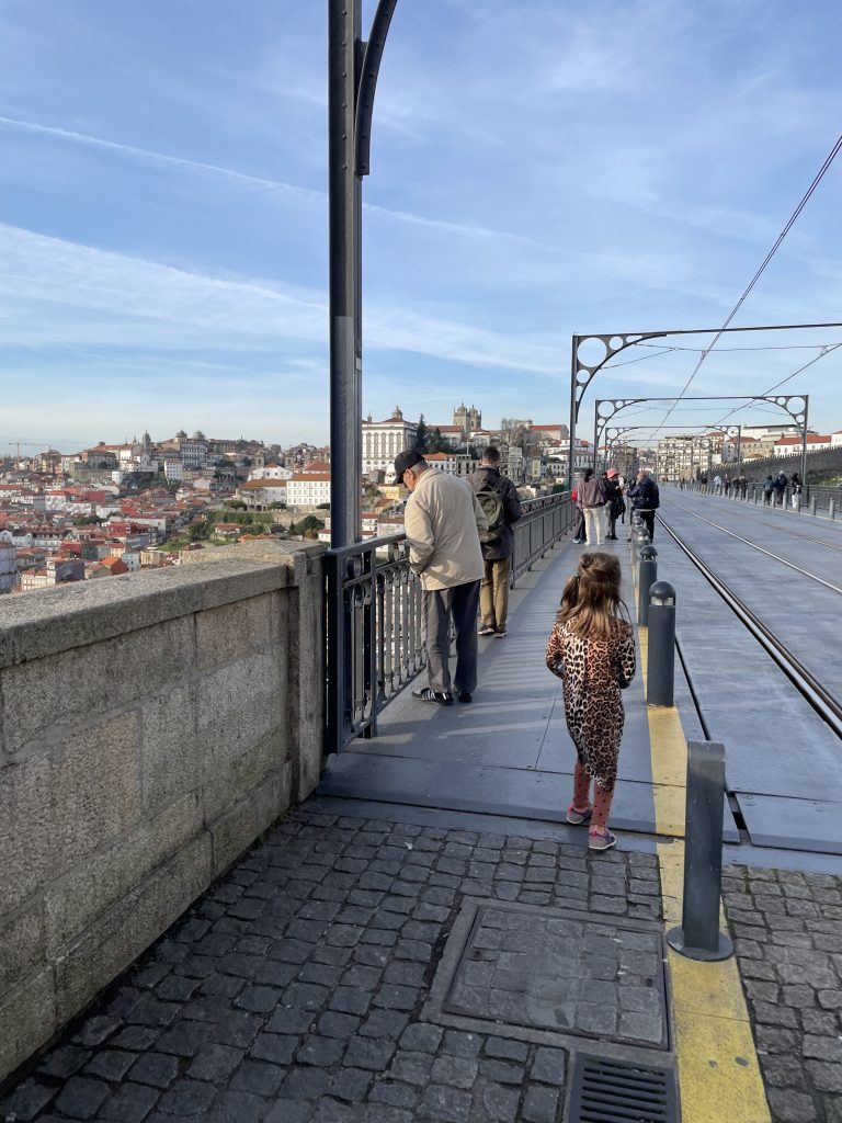 A child walking across the top deck of the Dom Luis I Bridge in Porto Portugal