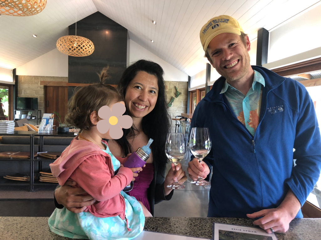 Two adults and a child cheers wine glasses in Blenheim New Zealand