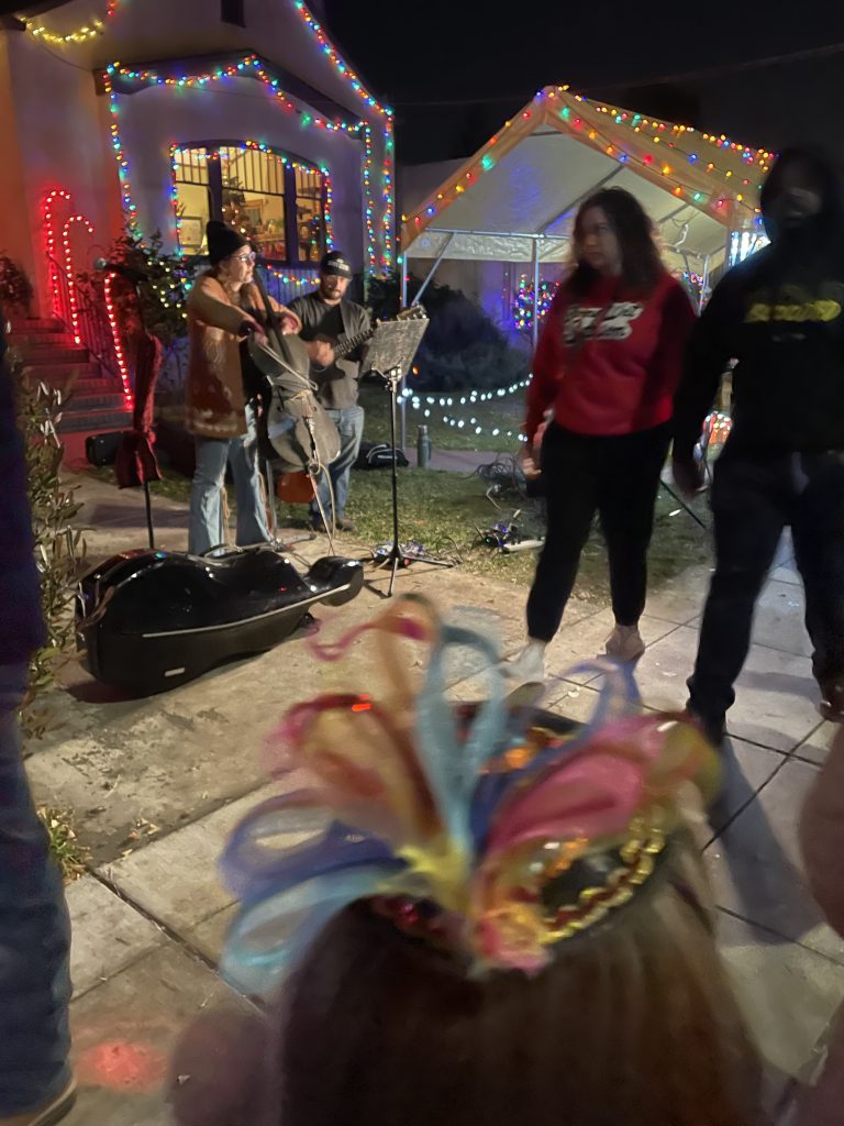 Child watching a live band on Christmas Tree Lane in Alameda California