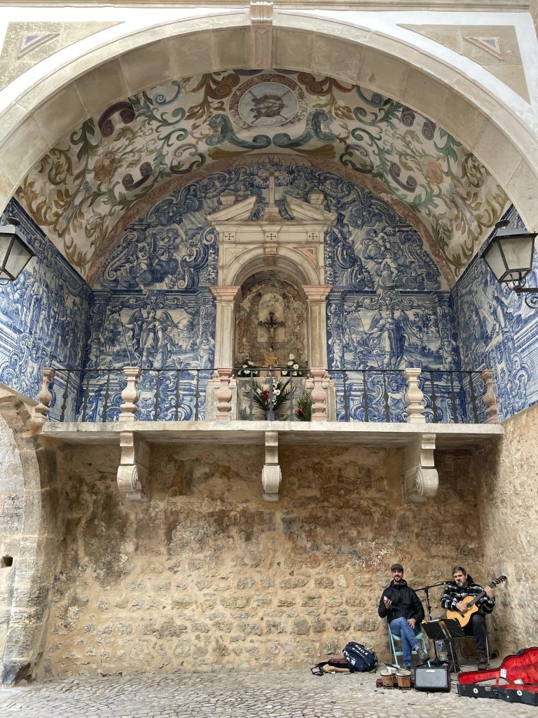 Two singers in the southern gate of Obidos Portugal surrounded by blue tile