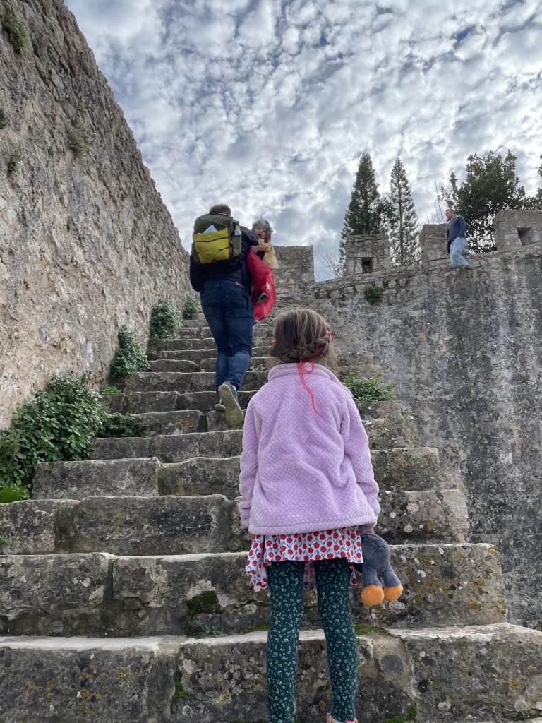 A child climbing stairs to the castle walls of Obidos Portugal