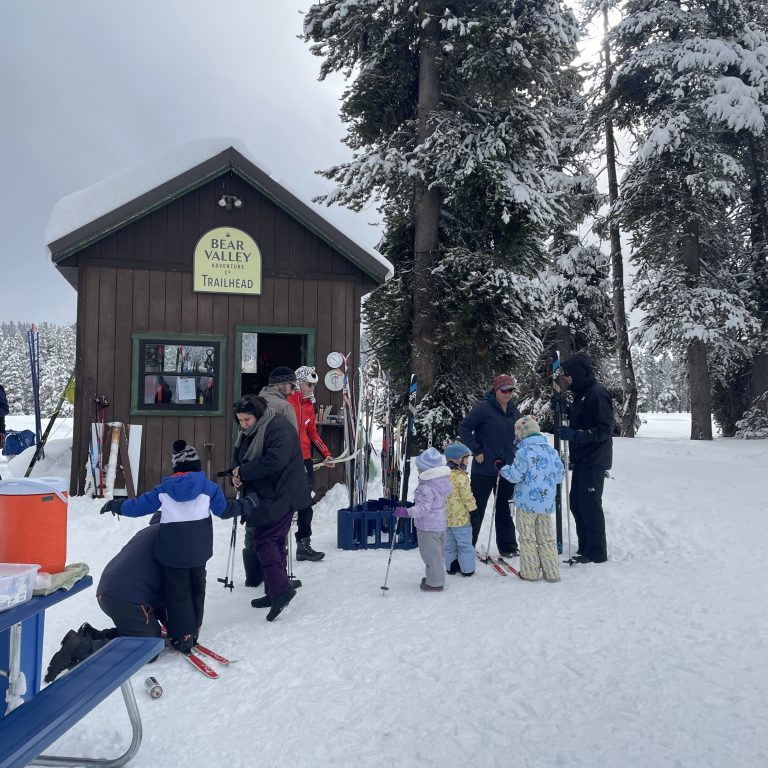 A line of kids renting cross country skis from Bear Valley Adventure Co in California