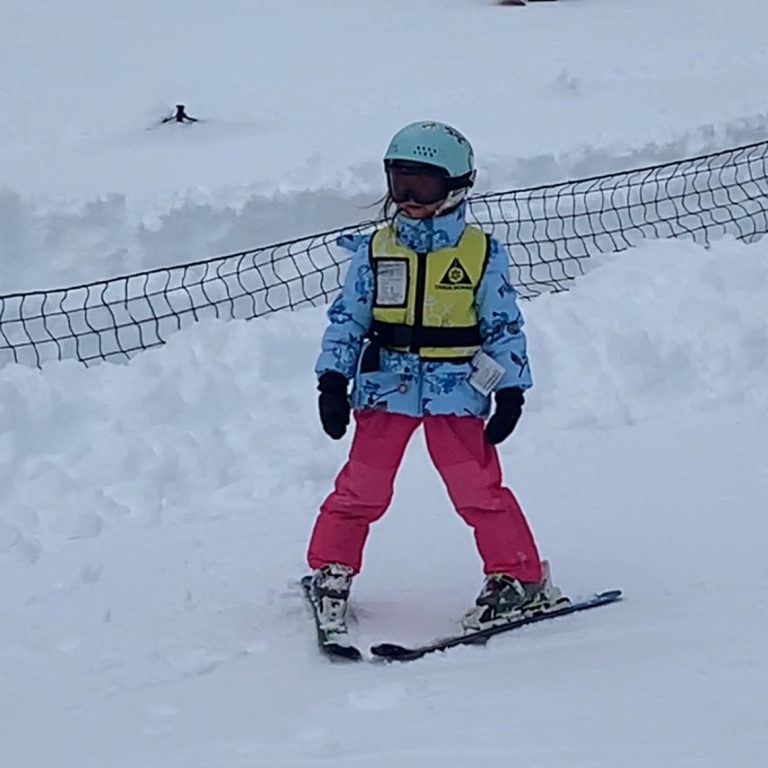 A child skiing down a slope at Bear Valley Resort in California