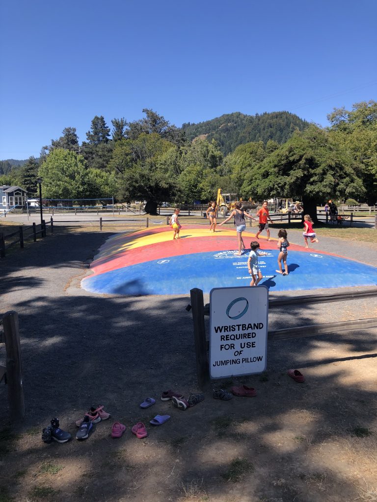 Children playing on a jumping pillow at Casini Ranch Family Campground in Duncan Mills