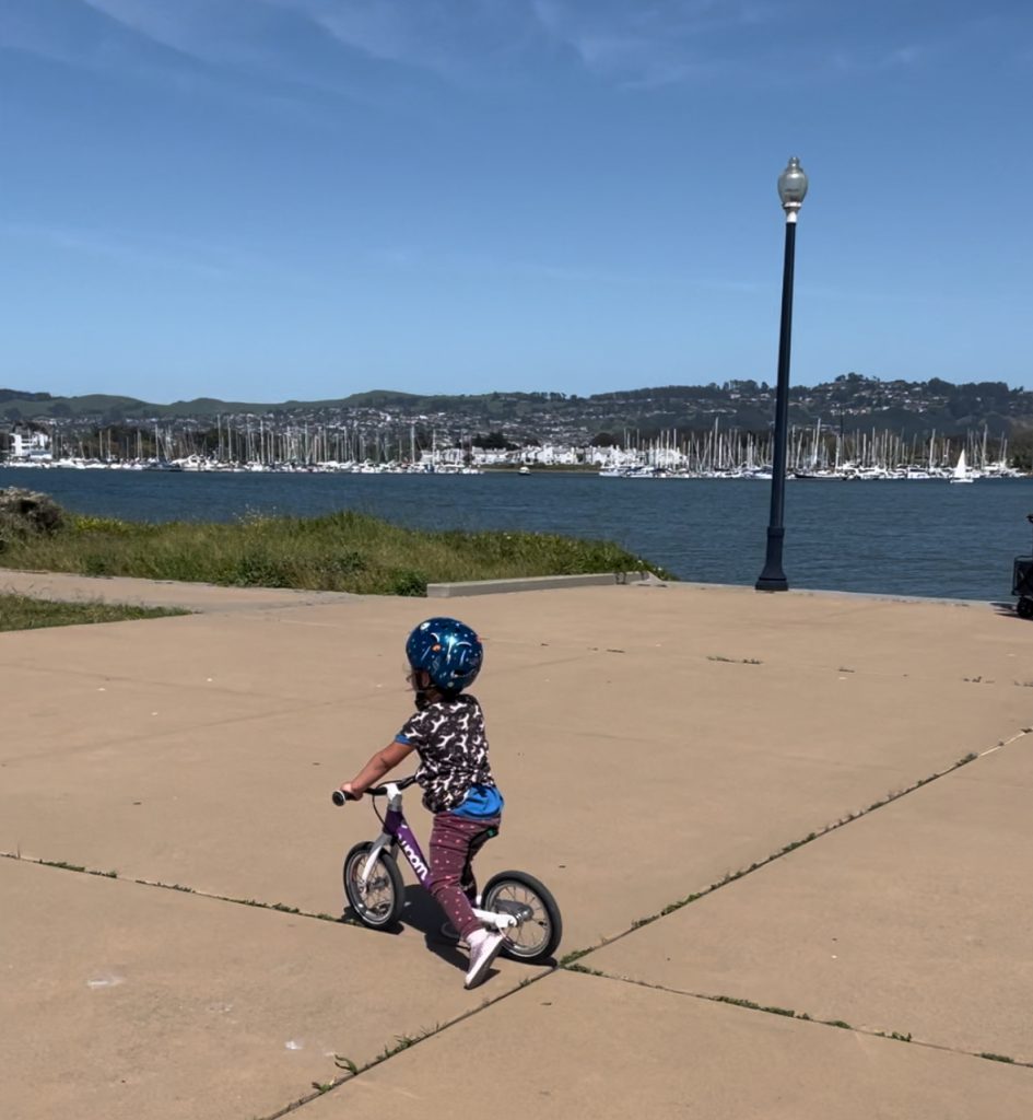 A child riding a woom 1 balance bike in Richmond California