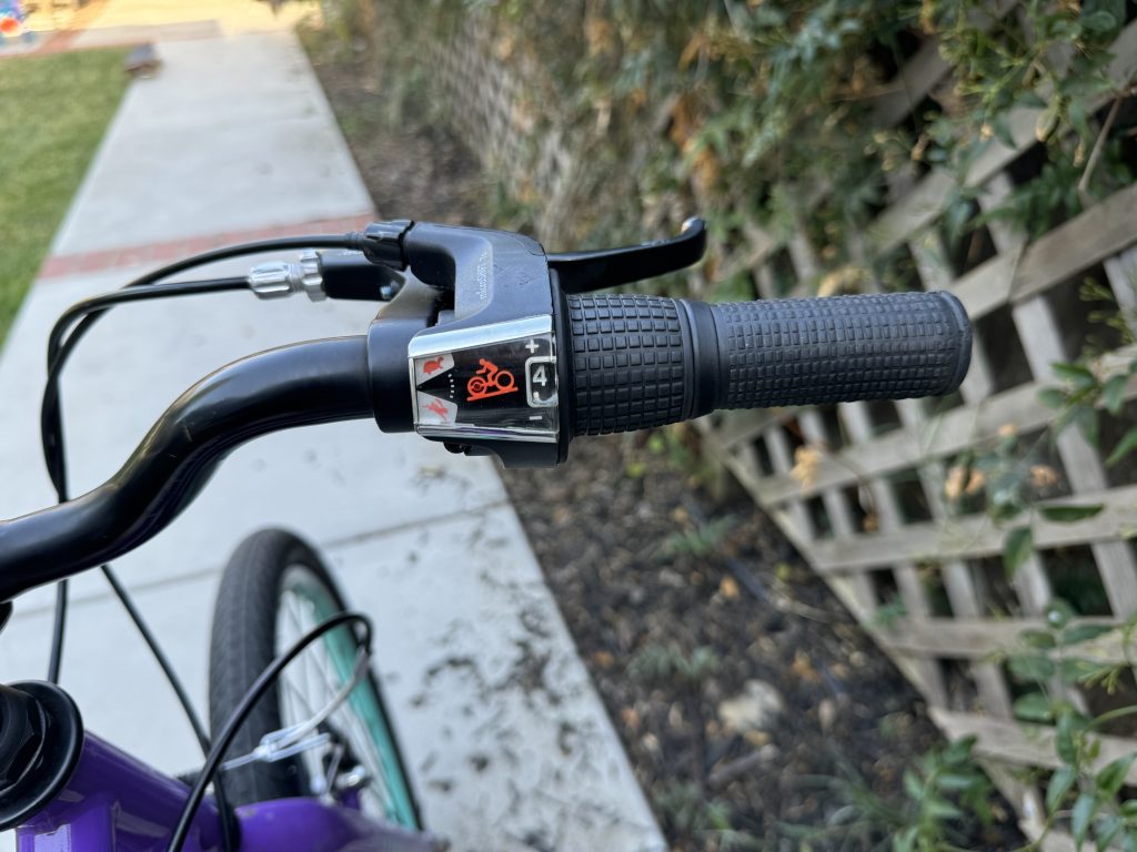 View of the easy to understand gear shifter on the Guardian Bikes' Ethos 20" purple aqua