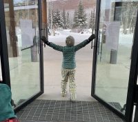 A child opening the doors at Chena Hot Springs in Fairbanks Alaska