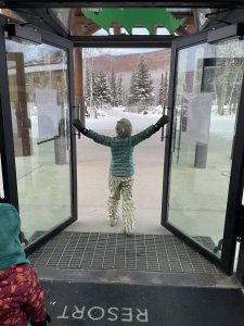 A child opening the doors at Chena Hot Springs in Fairbanks Alaska