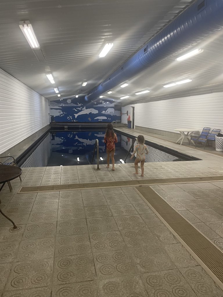 Two children entering the naturally heated indoor pool at Chena Hot Springs in Fairbanks, Alaska