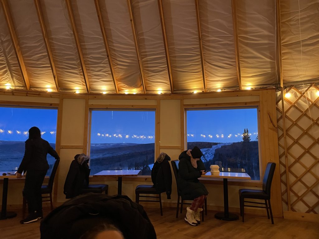 People eating inside Latitude 65 at Borealis Basecamp in Fairbanks Alaska