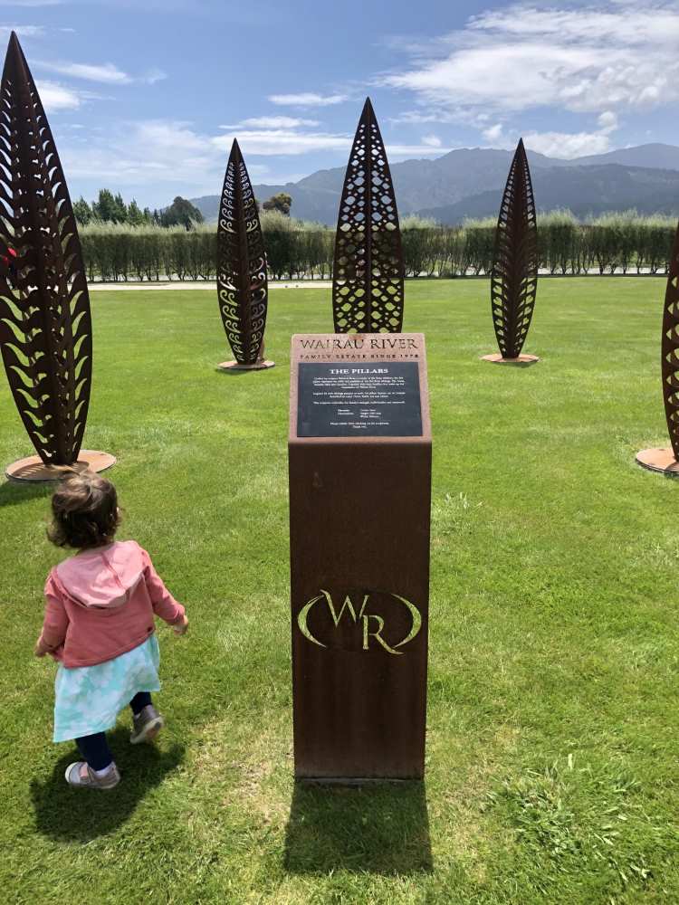 Child walking around leaf statues at Wairau River winery in New Zealand