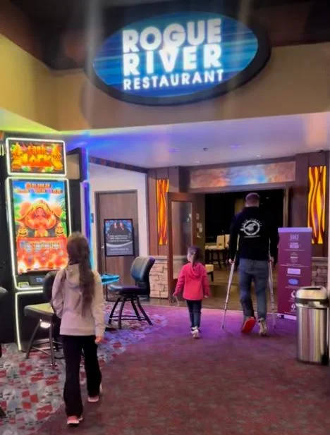 A child walking near slot machines towards the Rogue River Restaurant at Chinook Winds Casino Resort in Lincoln City, OR