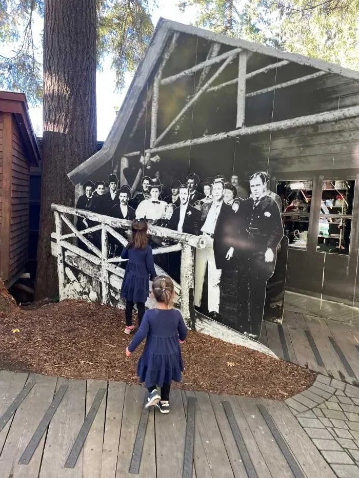 Children looking at a history display at Capilano Suspension Bridge Park in Vancouver Canada