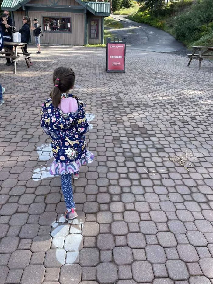 A child walking the bear tracks at Grouse Mountain Vancouver Canada