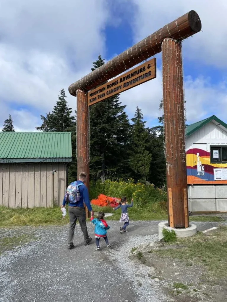 Kids and an adult walking to the adventure tree canopy at Grouse Mountain in Vancouver, Canada