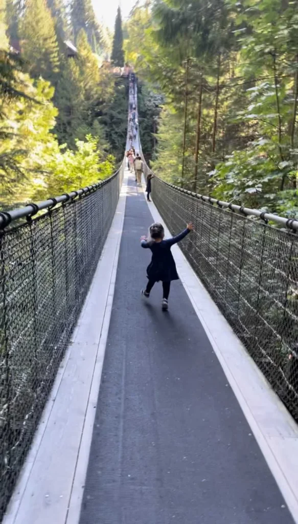 A child walking down the Capilano Suspension Bridge in Vancouver, Canada