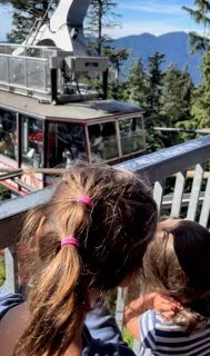 Children watching the gondola at Grouse Mountain Vancouver Canada