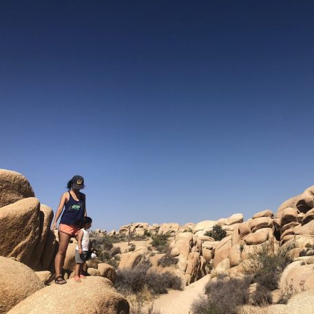 Angelica and her daughter pose along a rocky vista in Joshua Tree National Park.
