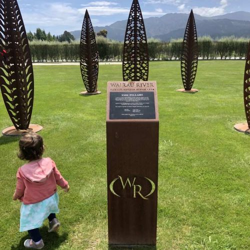Child walking around leaf statues at Wairau River winery in New Zealand