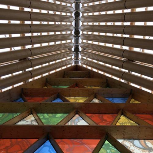 Rows of cardboard columns on top of stained glass triangles at the Cardboard Cathedral in Christchurch, NZ